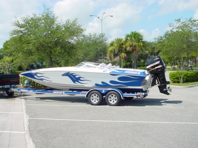 Blue flamed 24 Checkmate 300xs on trailer.jpg